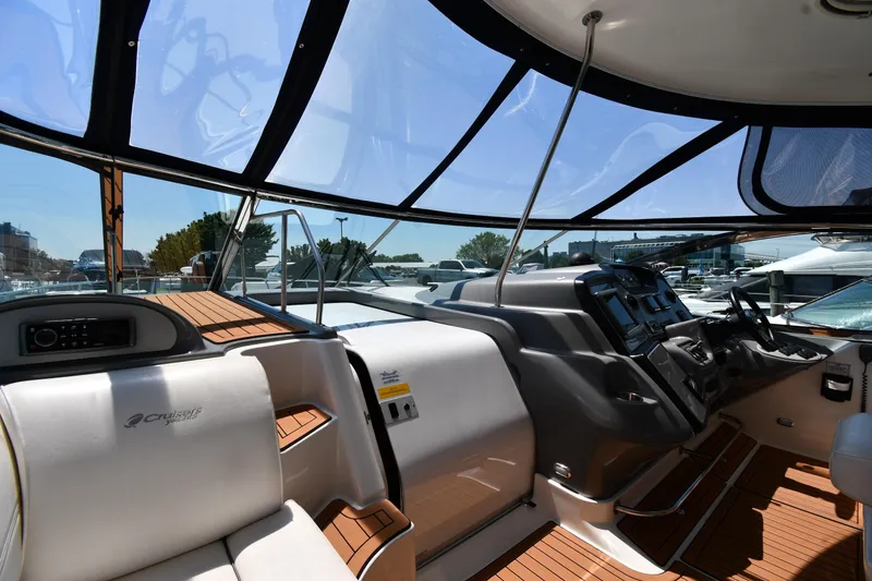 Slide: The Image of 2005 Cruisers Yachts 520 Express cockpit with modern controls and panoramic windows. - 12