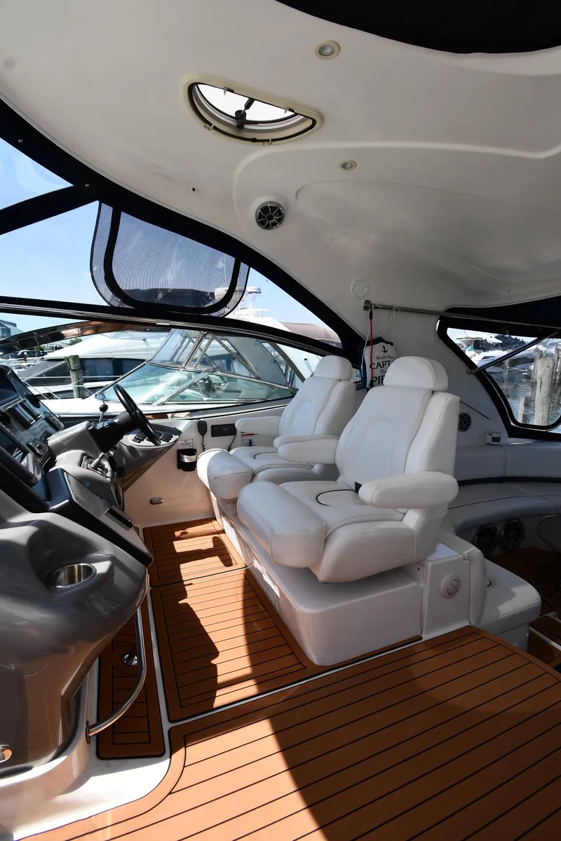 Slide: The Image of Interior of a 2005 Cruisers Yachts 520 Express with white leather seats. - 14