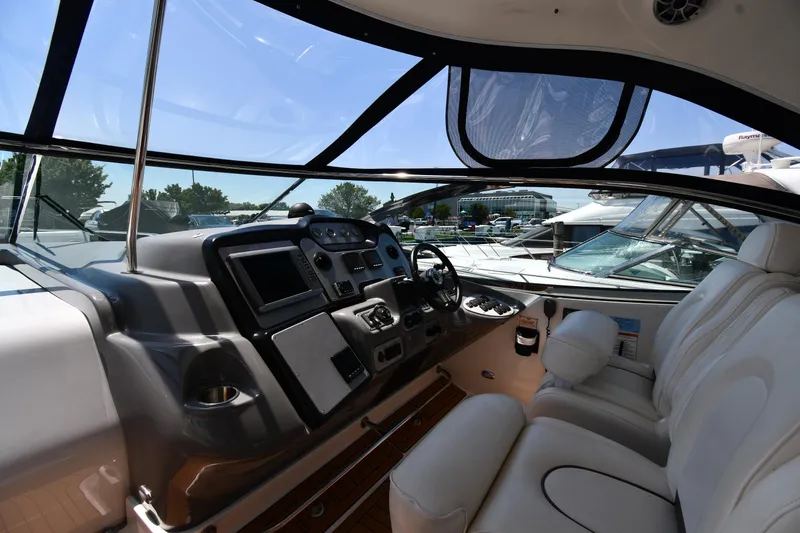 Slide: The Image of 2005 Cruisers Yachts 520 Express helm with modern controls and comfortable seating. - 15