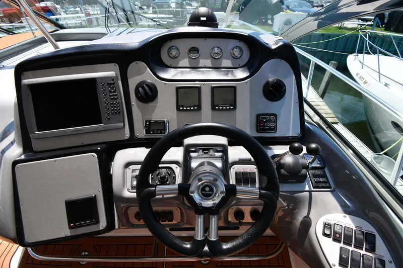 Slide: The Image of Helm of 2005 Cruisers Yachts 520 Express with advanced navigation controls. - 17