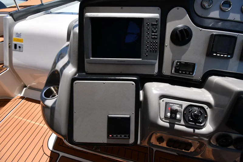 Slide: The Image of 2005 Cruisers Yachts 520 Express helm with navigation equipment and teak flooring. - 18