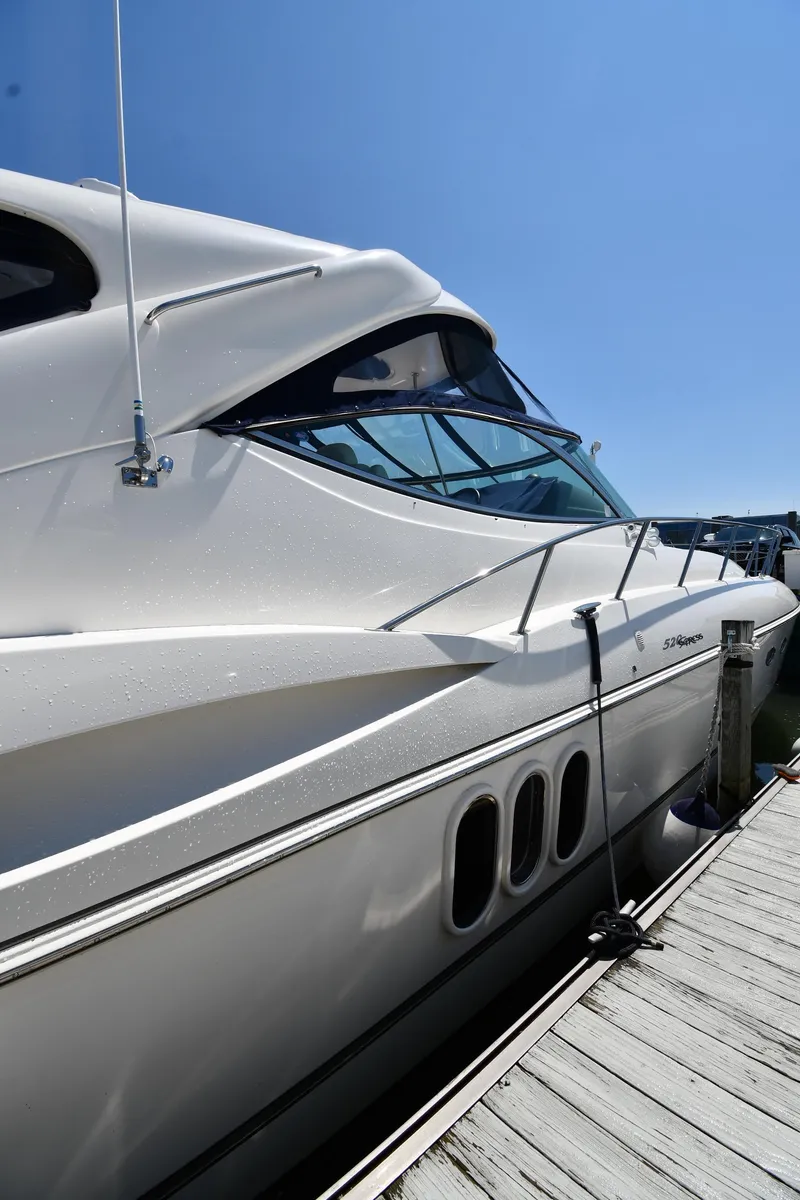Slide: The Image of 2005 Cruisers Yachts 520 Express docked under clear blue sky. - 2