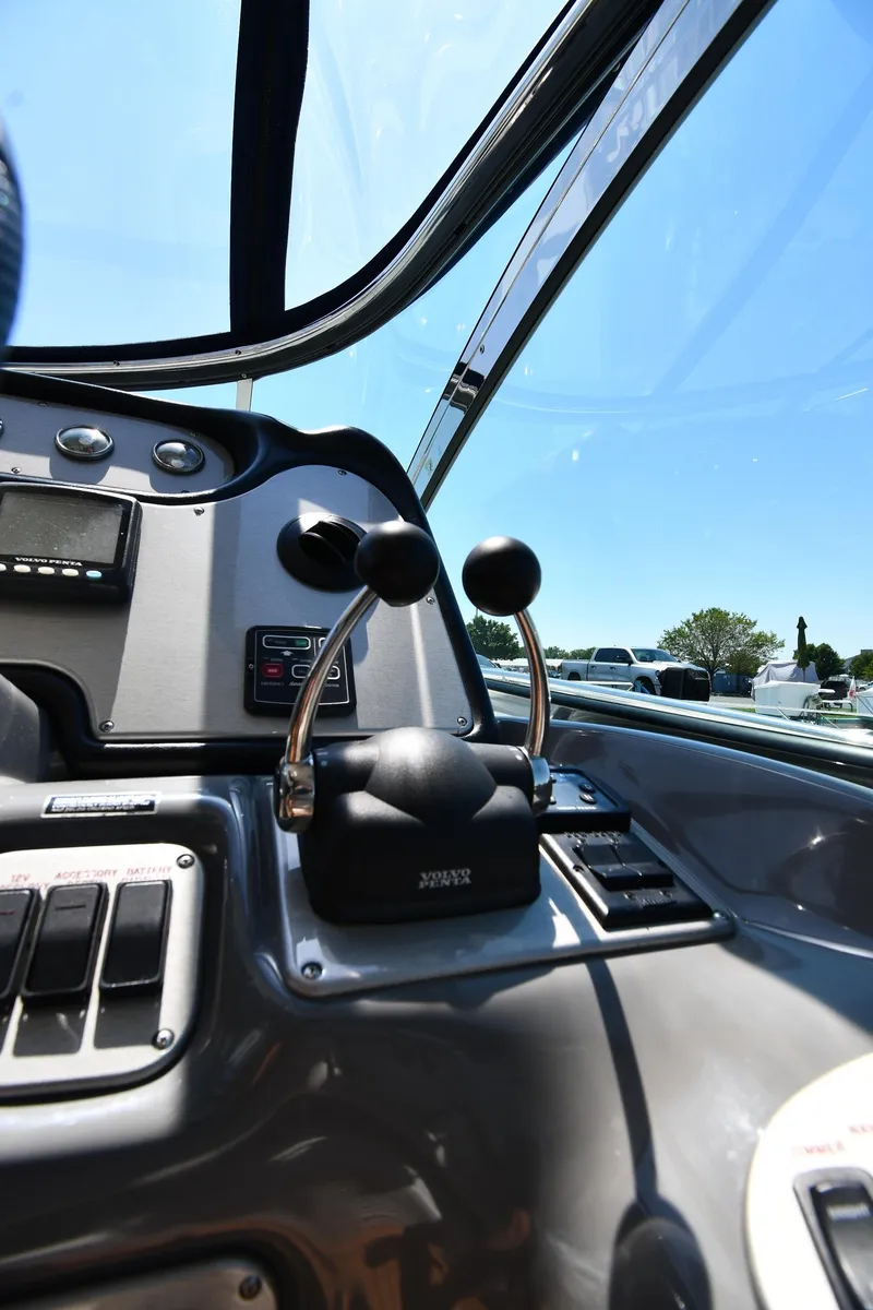 Slide: The Image of 2005 Cruisers Yachts 520 Express helm controls and dashboard. - 20
