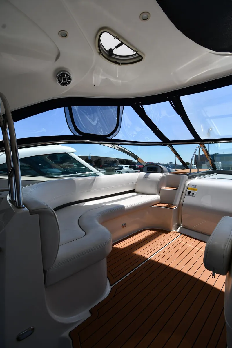 Slide: The Image of Interior of a 2005 Cruisers Yachts 520 Express with white seating and wooden flooring. - 21