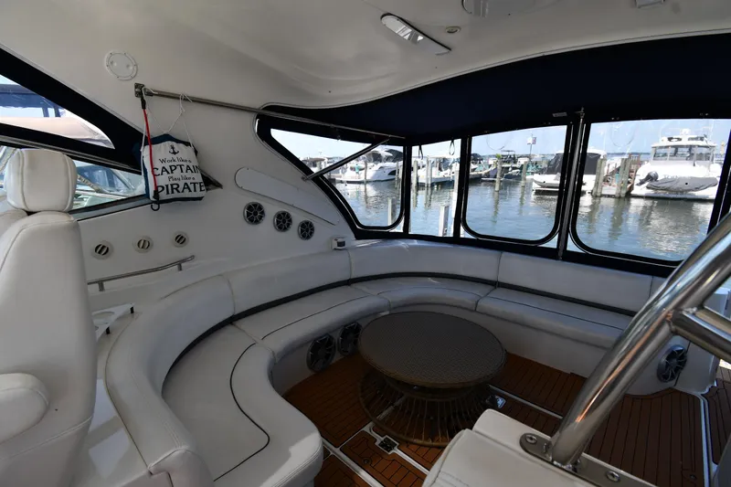 Slide: The Image of Interior of 2005 Cruisers Yachts 520 Express with white seating and marina view. - 26