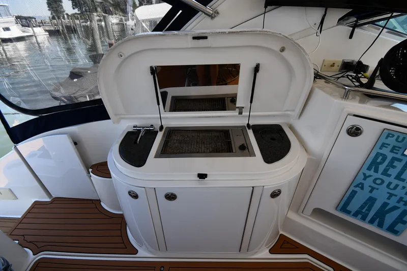 Slide: The Image of 2005 Cruisers Yachts 520 Express cockpit with open storage compartment. - 28