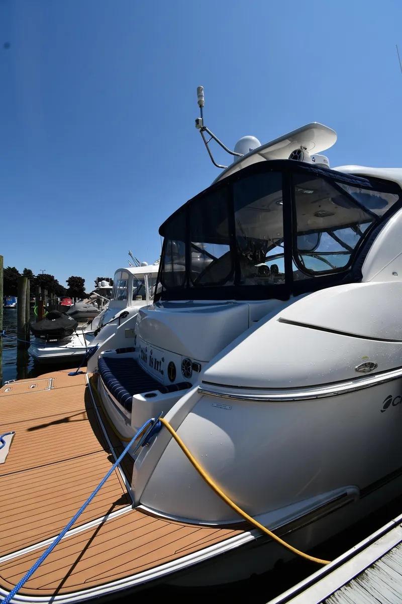Slide: The Image of 2005 Cruisers Yachts 520 Express docked at a marina on a sunny day. - 3