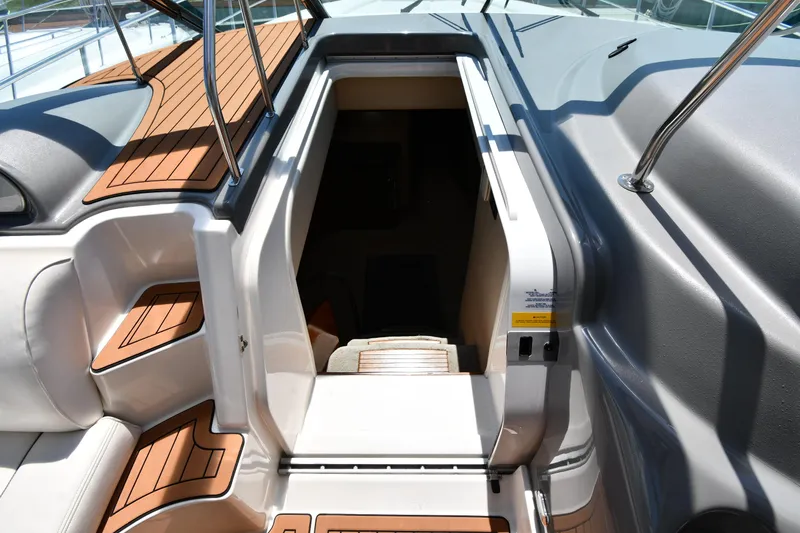 Slide: The Image of 2005 Cruisers Yachts 520 Express cabin entrance with teak steps and seating. - 30