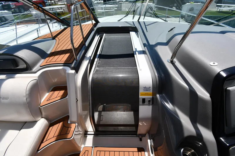 Slide: The Image of 2005 Cruisers Yachts 520 Express cockpit with teak flooring and sliding door. - 31