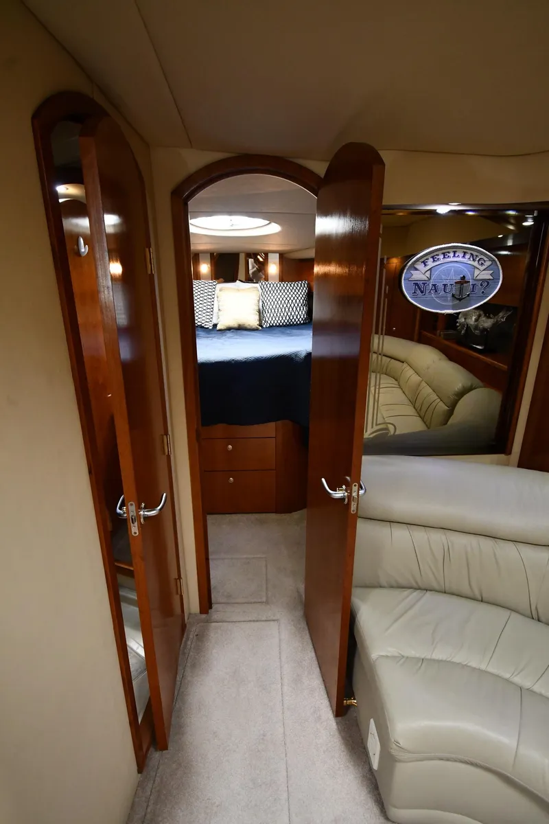 Slide: The Image of Interior cabin of 2005 Cruisers Yachts 520 Express with wooden doors and cozy bed. - 32