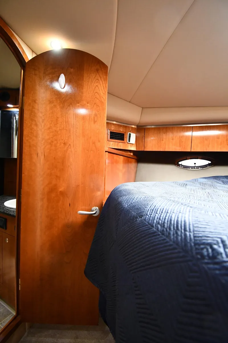 Slide: The Image of Interior cabin of 2005 Cruisers Yachts 520 Express with wooden finishes and bed. - 35