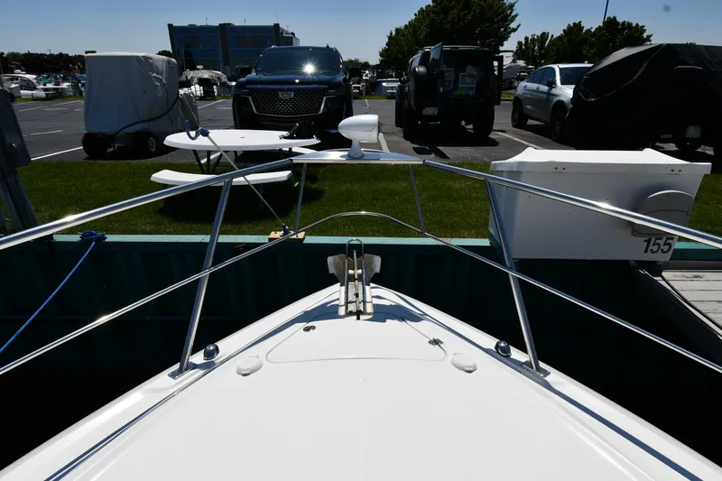Slide: The Image of 2005 Cruisers Yachts 520 Express docked at marina, front view. - 4