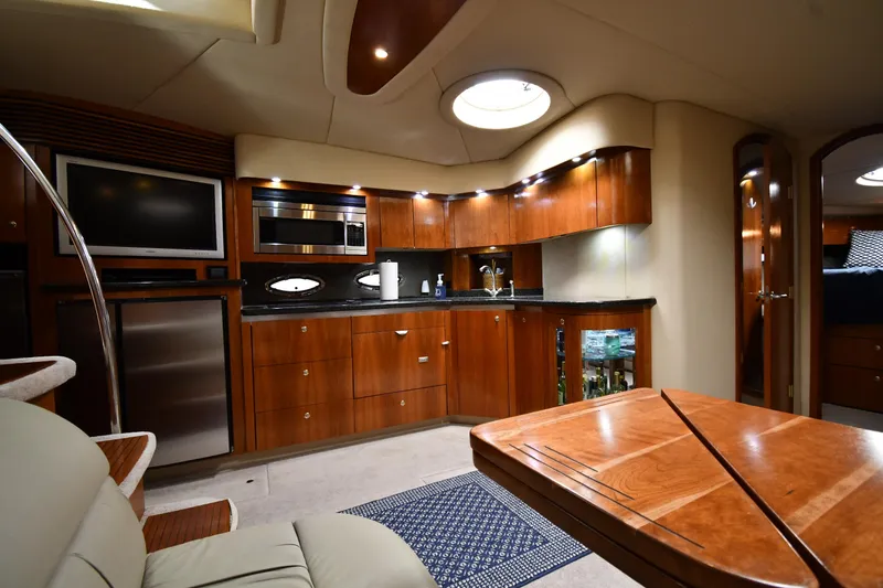 Slide: The Image of Luxurious interior of 2005 Cruisers Yachts 520 Express with modern kitchen and seating area. - 44