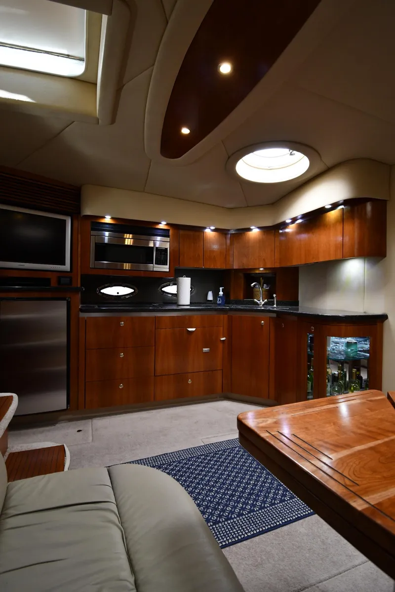 Slide: The Image of Luxurious interior of 2005 Cruisers Yachts 520 Express with modern kitchen and seating area. - 45