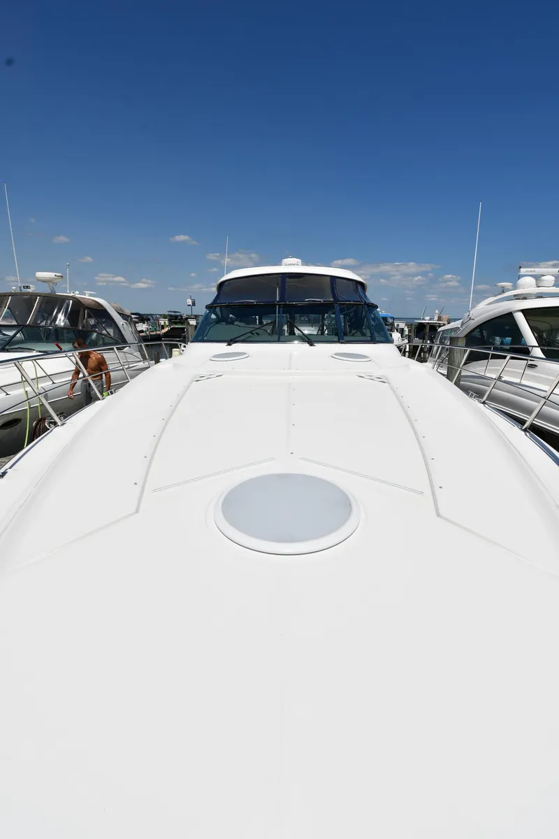 Slide: The Image of 2005 Cruisers Yachts 520 Express docked under a clear blue sky. - 7