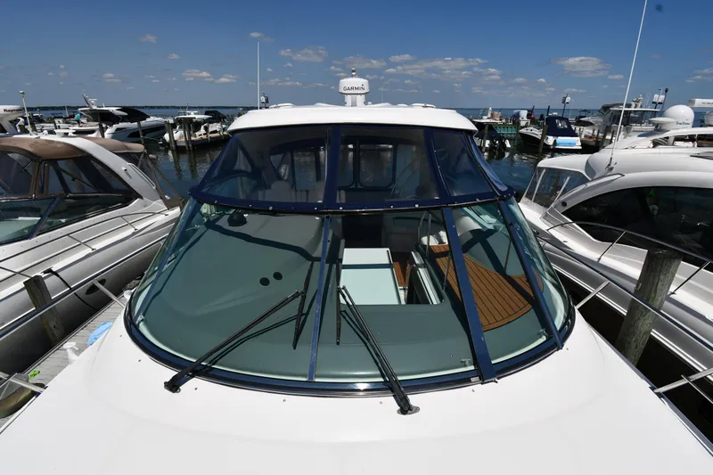 Slide: The Image of 2005 Cruisers Yachts 520 Express docked at a marina, front view. - 8