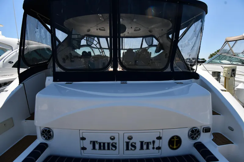 Slide: The Image of 2005 Cruisers Yachts 520 Express stern view with This Is It! sign. - 9