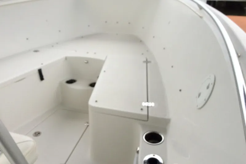 Slide: The Image of 2011 Sailfish Center Console boat interior with cup holders and storage compartments. - 12