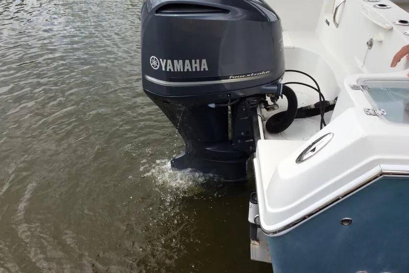 Slide: The Image of Outboard motor on 2011 Sailfish Center Console boat in water. - 13