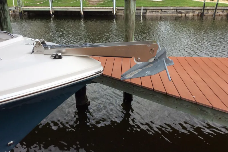 Slide: The Image of 2011 Sailfish Center Console boat with anchor near wooden dock. - 3