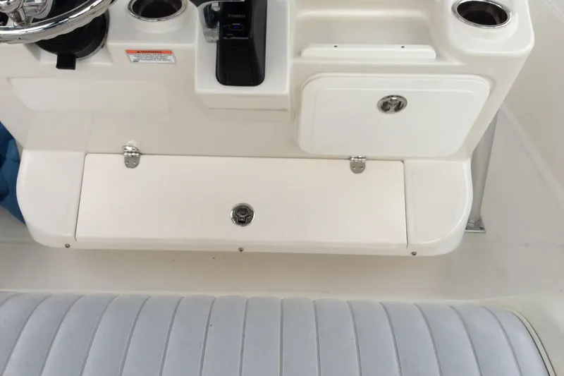 Slide: The Image of 2011 Sailfish Center Console boat interior with steering wheel and storage compartments. - 7
