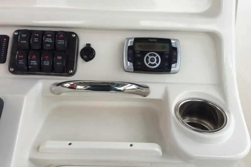 Slide: The Image of 2011 Sailfish Center Console dashboard with controls, stereo, and cup holder. - 8