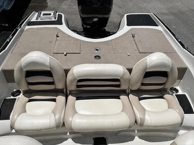 Slide: The Image of 2013 Nitro Z7 Sport boat interior with cushioned seating and motor. - 10