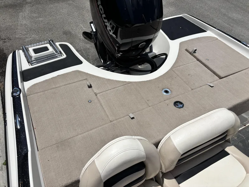 Slide: The Image of 2013 Nitro Z7 Sport boat with Mercury engine, featuring beige seating and deck. - 11