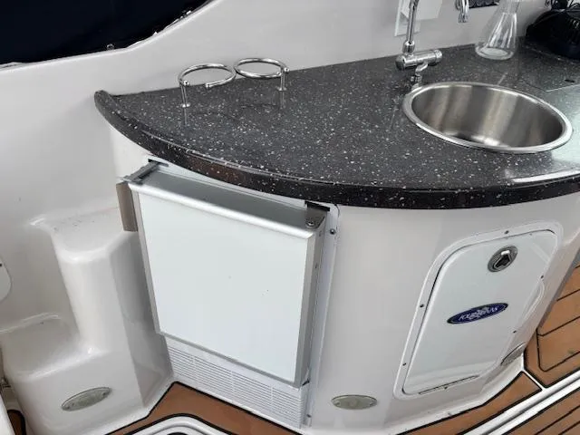 Slide: The Image of 2007 Four Winns 378 Vista yacht kitchenette with sink, countertop, and mini fridge. - 15
