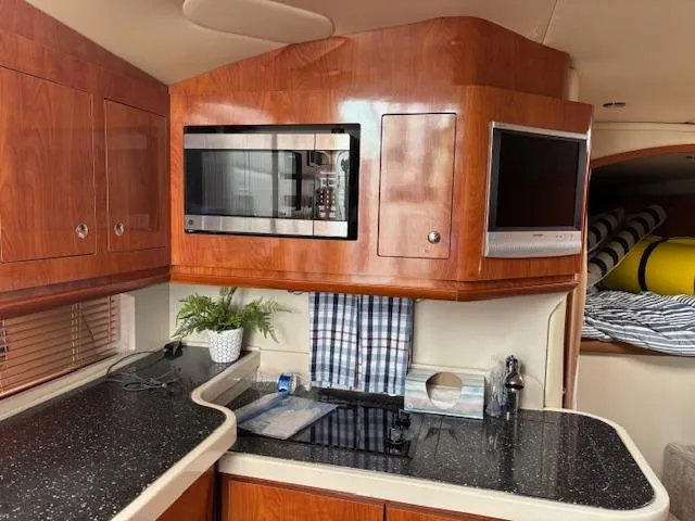 Slide: The Image of 2007 Four Winns 378 Vista yacht kitchen with microwave, TV, and sleek countertops. - 17