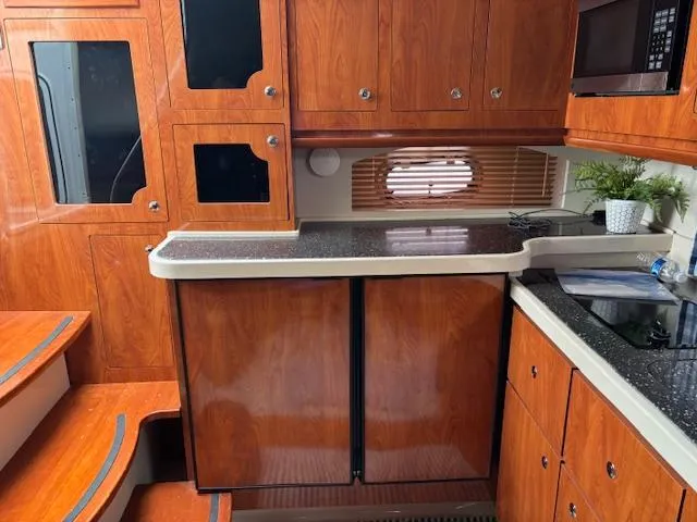 Slide: The Image of 2007 Four Winns 378 Vista yacht kitchenette with sink, mini fridge, and countertop. - 2