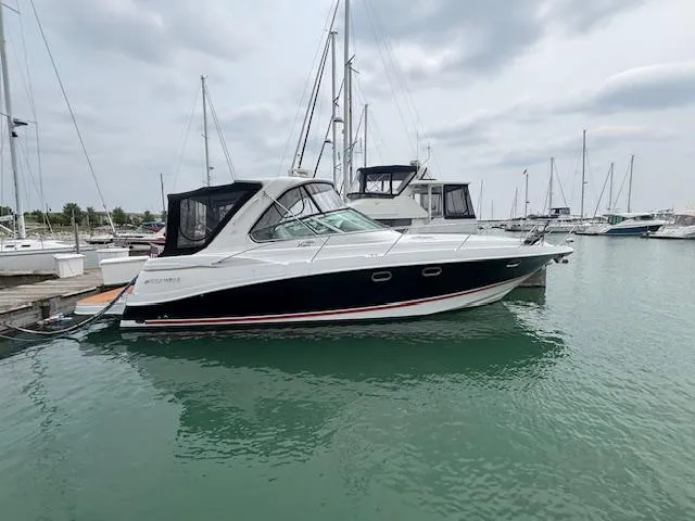 Slide: The Image of 2007 Four Winns 378 Vista yacht docked in a marina with sailboats. - 22