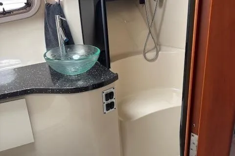 Slide: The Image of 2007 Four Winns 378 Vista bathroom with glass sink and shower. - 23