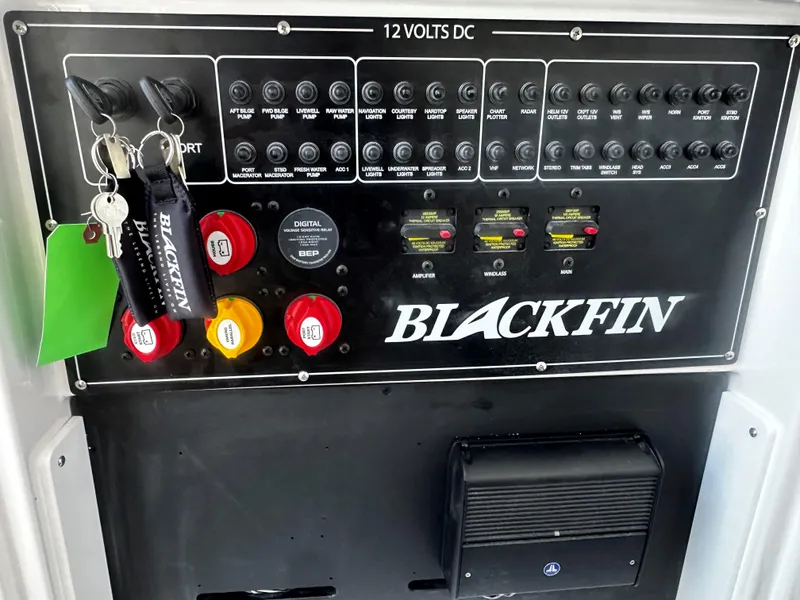Slide: The Image of Control panel of 2025 Blackfin 272CC boat with switches and keys. - 12