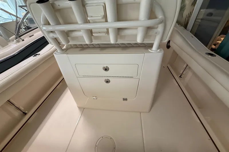 Slide: The Image of 2026 Grady-White Fisherman 216 boat interior with rod holders and storage compartments. - 10