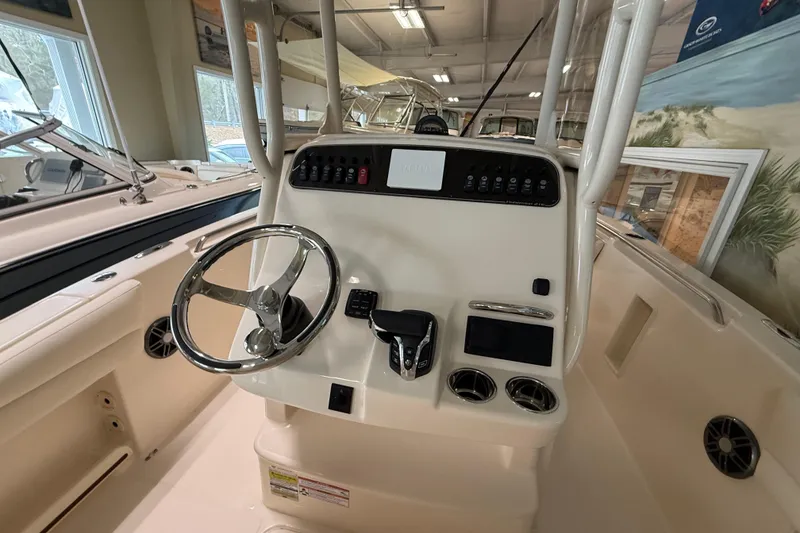 Slide: The Image of 2026 Grady-White Fisherman 216 boat console with steering wheel and controls. - 13