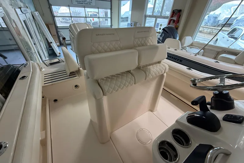 Slide: The Image of 2026 Grady-White Fisherman 216 boat interior with steering wheel and cushioned seating. - 15