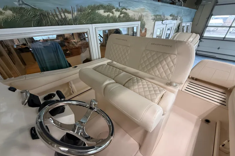 Slide: The Image of 2026 Grady-White Fisherman 216 boat interior with luxurious seating and steering wheel. - 16
