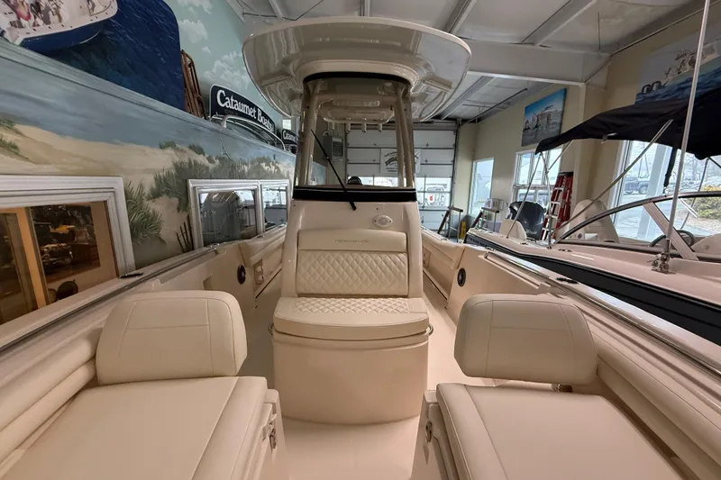 Slide: The Image of 2026 Grady-White Fisherman 216 boat interior with cushioned seating and helm station. - 18