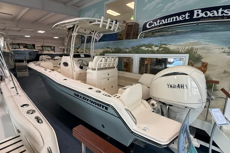 Slide: The Image of 2026 Grady-White Fisherman 216 boat with Yamaha engine displayed indoors. - 4