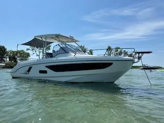 Slide: The Image of 2023 Beneteau Flyer 9 SUNdeck boat on calm water under clear sky. - 1