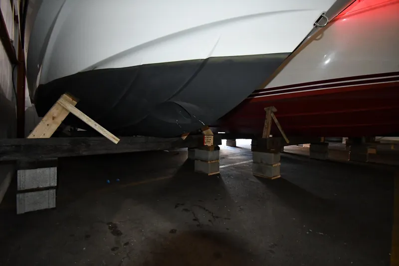 Slide: The Image of 2023 Beneteau Flyer 9 SUNdeck boat hull supported on blocks in storage. - 10