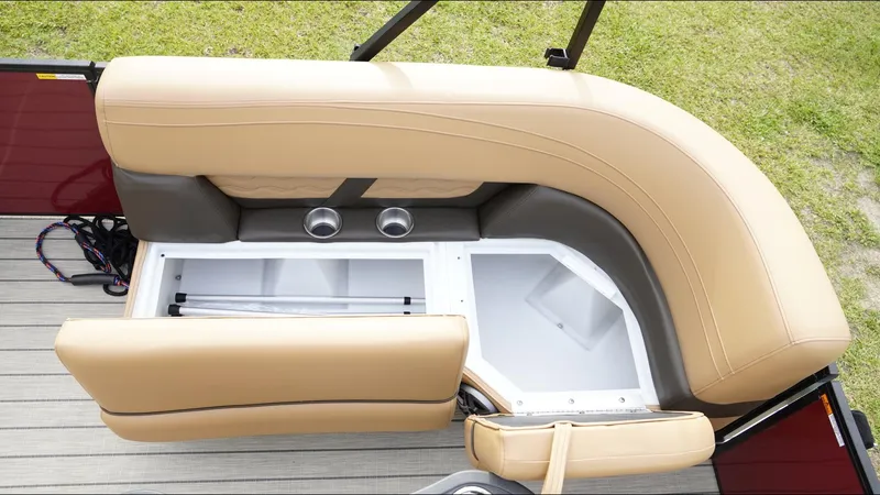 Slide: The Image of 2025 SunCatcher Fusion 324SS boat seating with storage compartment and cup holders. - 17