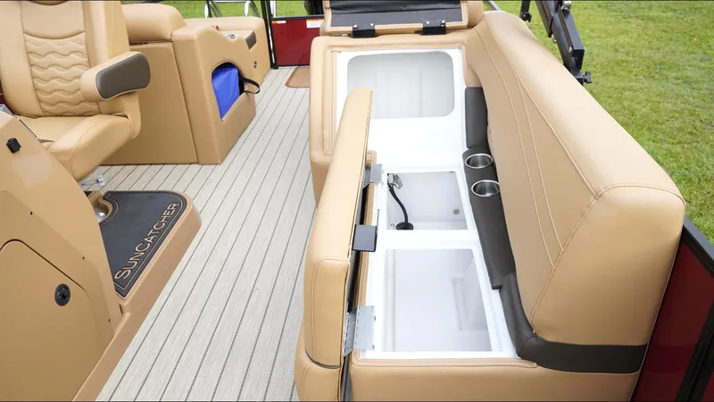 Slide: The Image of 2025 SunCatcher Fusion 324SS boat interior with tan seating and storage compartments. - 19