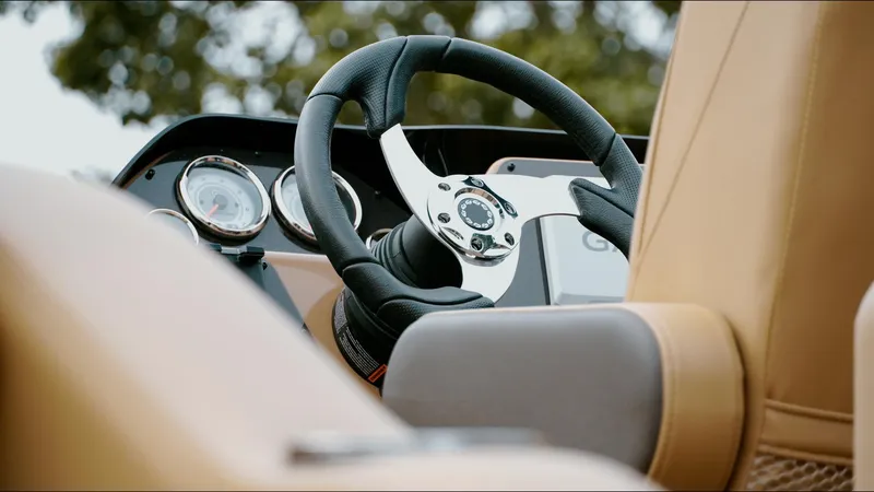 Slide: The Image of Steering wheel and dashboard of 2025 SunCatcher Fusion 324SS boat, featuring modern design. - 8