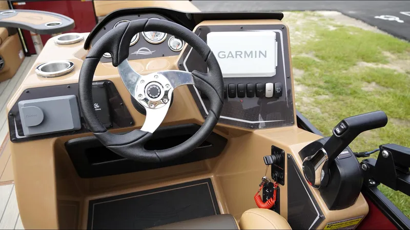 Slide: The Image of 2025 SunCatcher Fusion 324SS boat dashboard with Garmin navigation system and steering wheel. - 9
