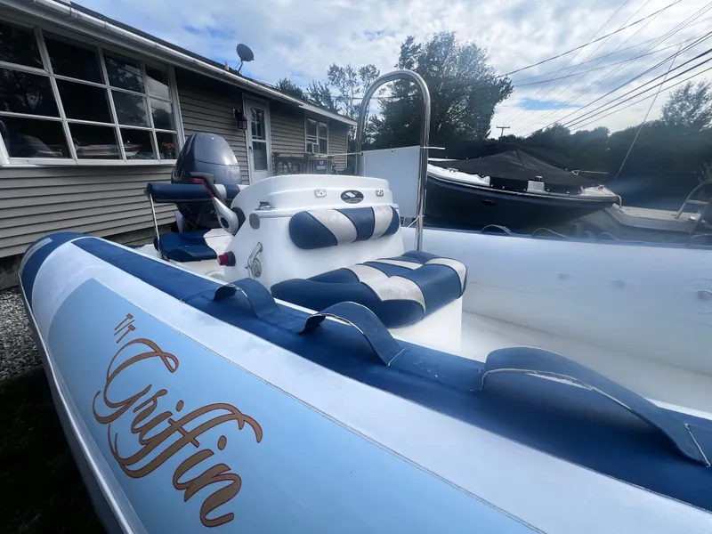 Slide: The Image of Smuggler Strata 520 boat, 2015 model, with blue and white seating, parked outdoors. - 7