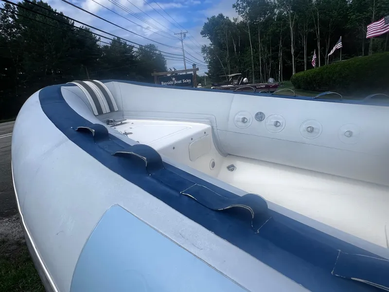 Slide: The Image of 2015 Smuggler Strata 520 boat interior at Bayside Boat Sales, with American flags in background. - 8