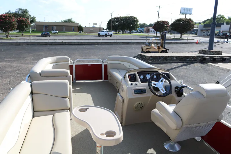 Slide: The Image of 2013 Bennington 22 SLX pontoon boat interior with beige seating and steering console. - 10