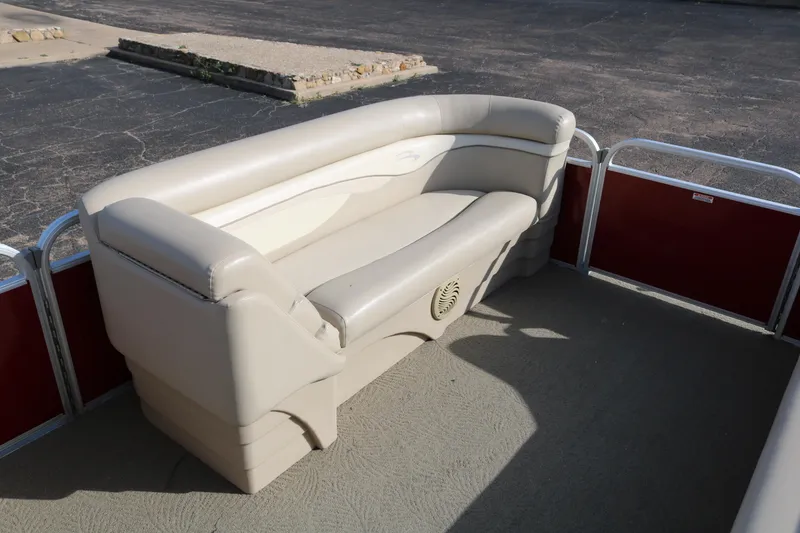 Slide: The Image of 2013 Bennington 22 SLX pontoon boat interior with beige seating and red paneling. - 11